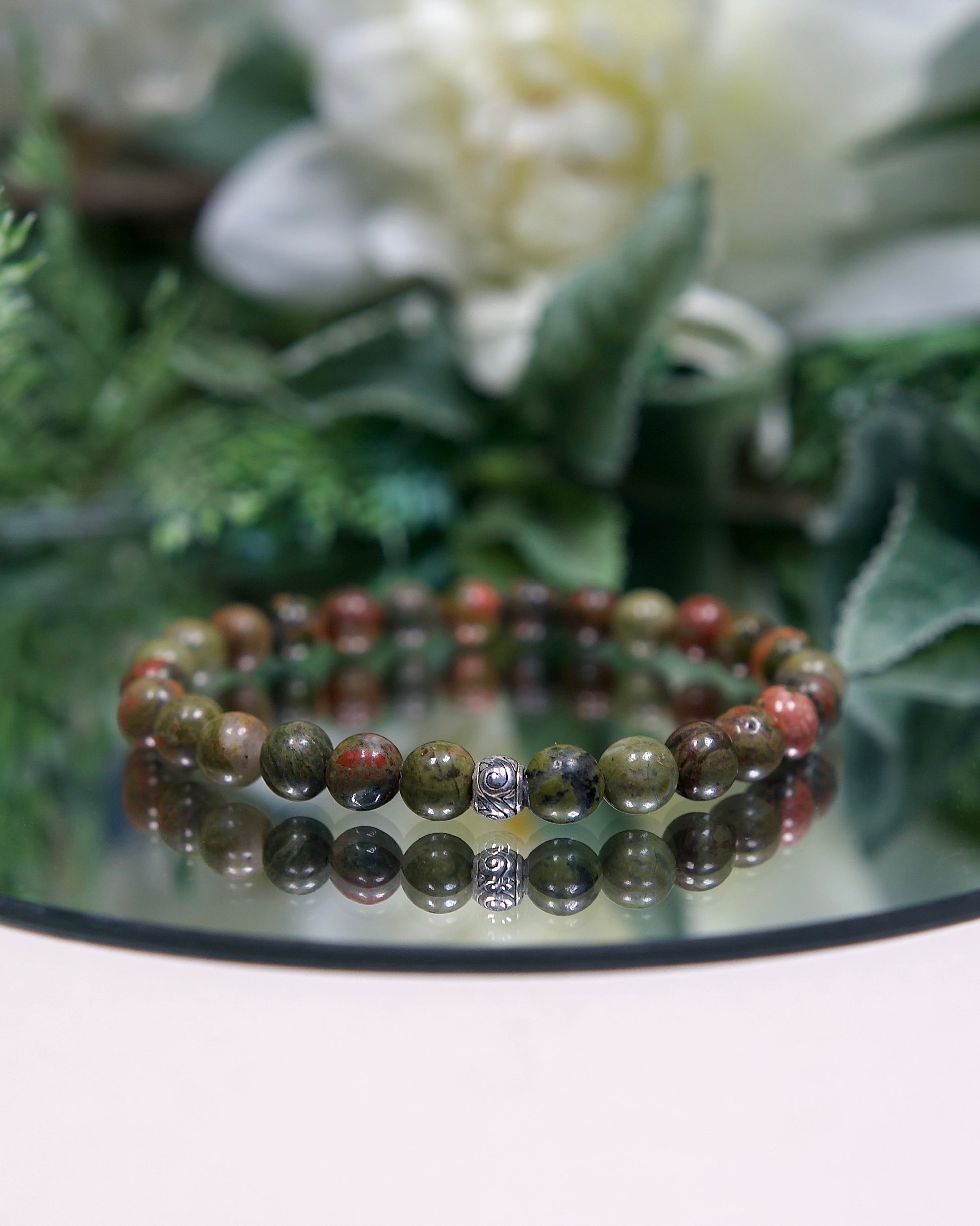 Close up photo of Unakite gemstone beaded bracelet with sterling silver accent