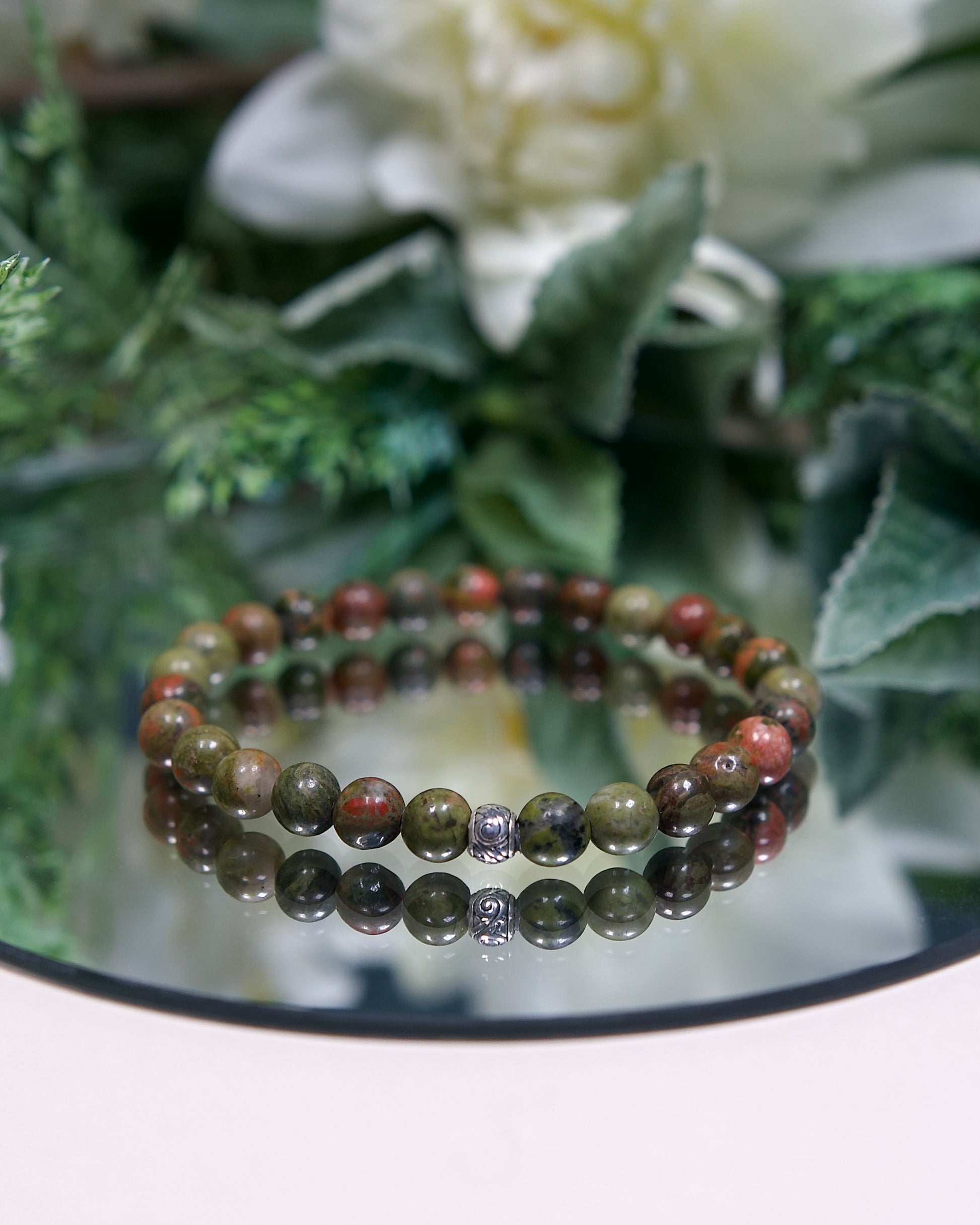 Close up photo of Unakite gemstone beaded bracelet with sterling silver accent