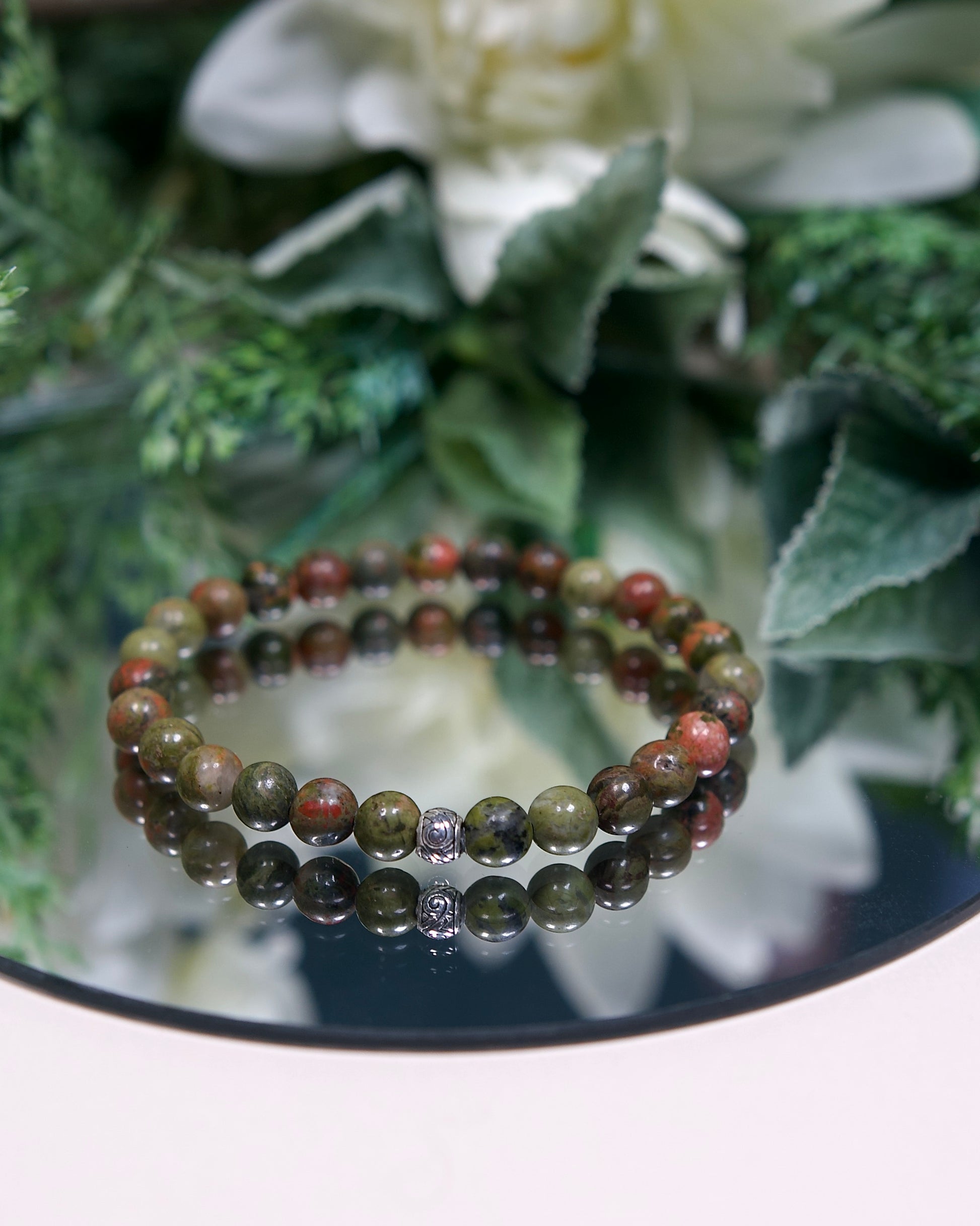 Close up photo of Unakite gemstone beaded bracelet with sterling silver accent