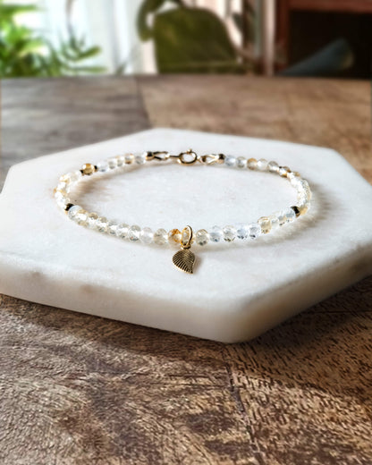 Yellow and clear citrine gemstone beaded bracelet with 14k gold-filled leaf-shaped charm and spring ring clasp.