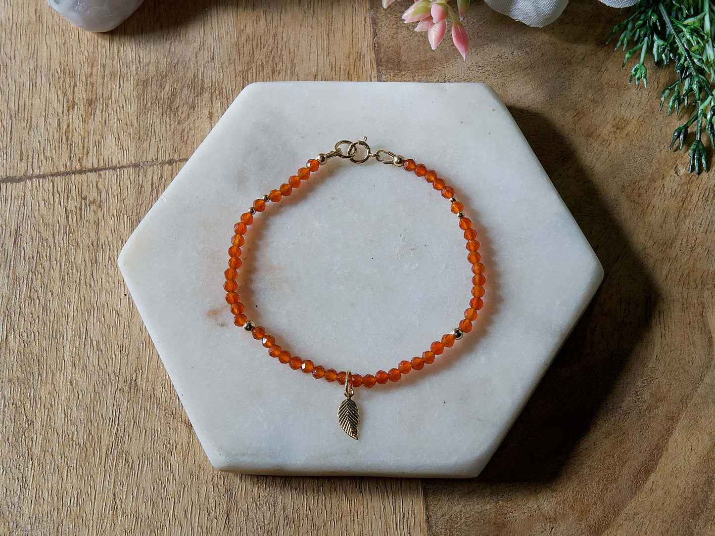 Orange carnelian gemstone beaded bracelet with 14k gold-filled leaf-shaped charm and spring ring clasp.