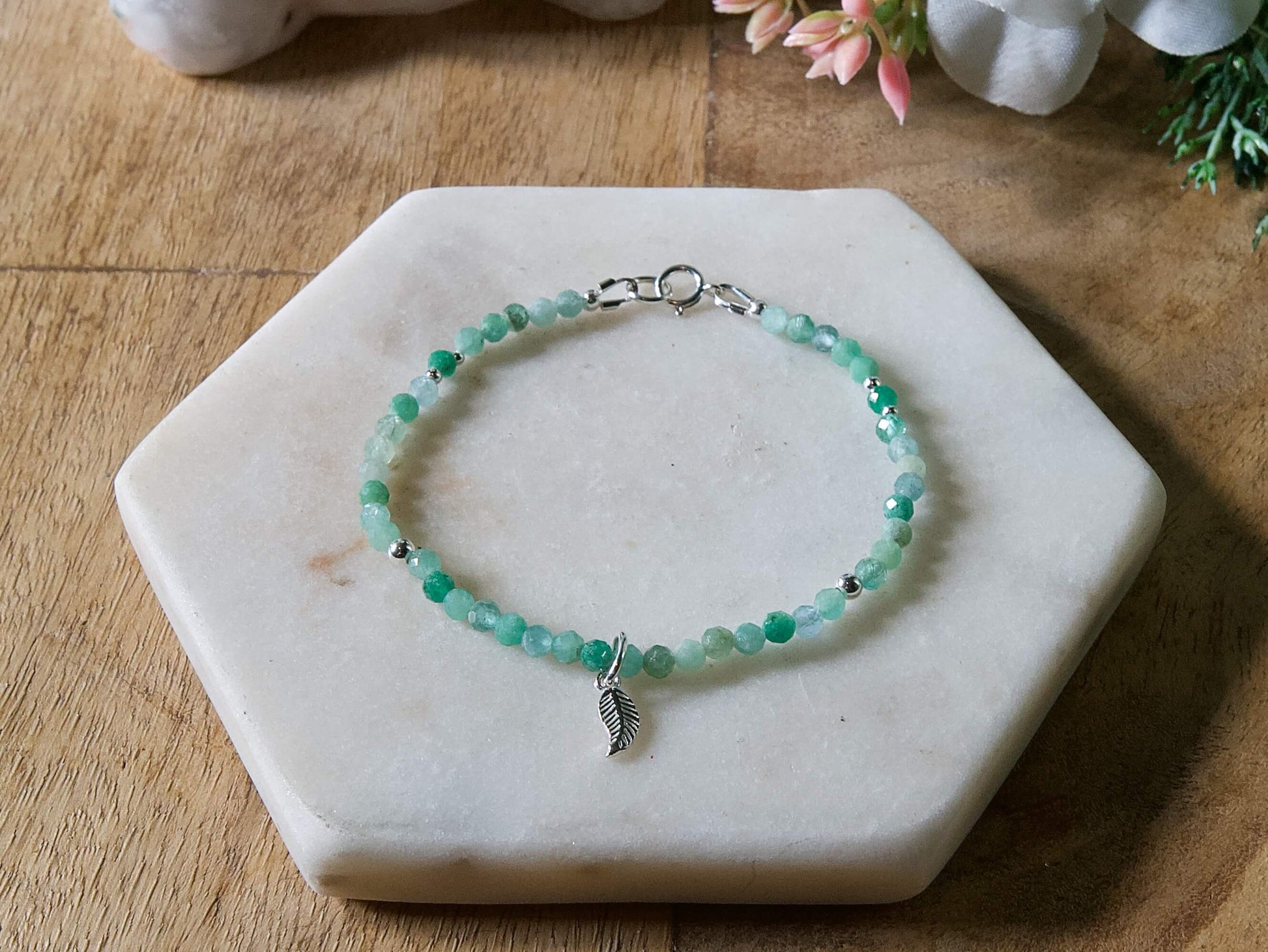 Green chrysoprase gemstone bracelet with sterling silver leaf-shaped charm and spring ring clasp.