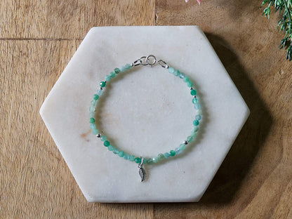 Green chrysoprase gemstone bracelet with sterling silver leaf-shaped charm and spring ring clasp.