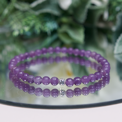 Lavender purple Lepidolite beaded bracelet with smooth round beads and a hammered sterling silver accent bead on mirrored plate
