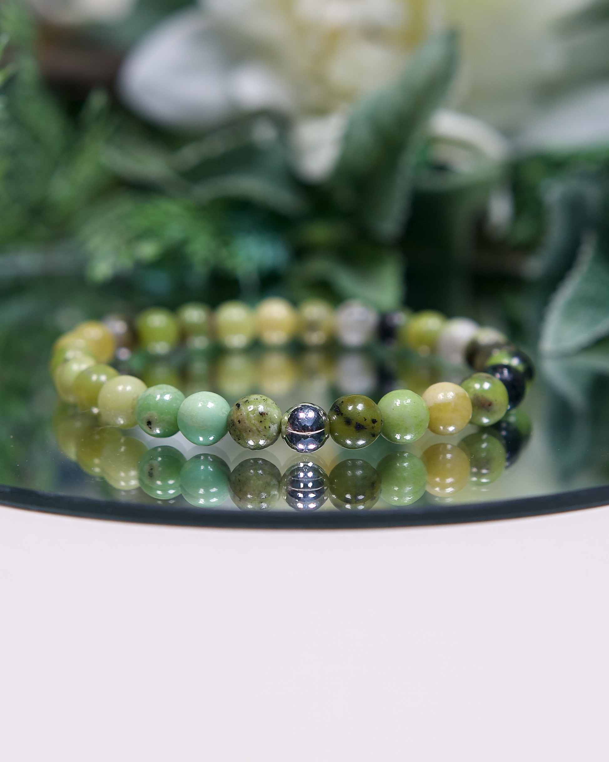 Close up of green chrysoprase beaded bracelet with sterling silver accent bead.