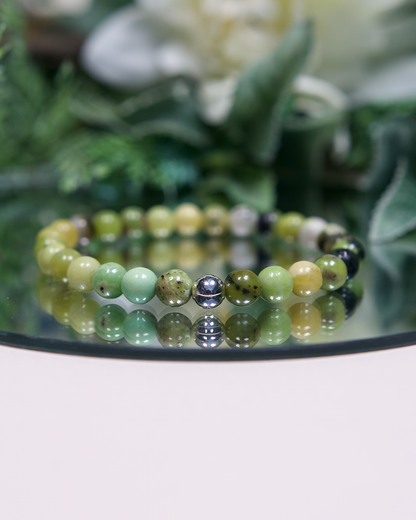 Multi-tonal green round Chrysoprase beaded bracelet with sterling silver accent bead on mirrored plate