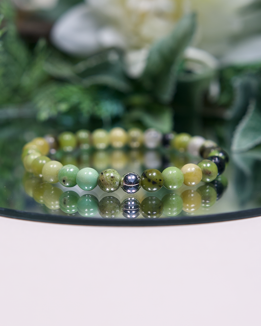 Multi-tonal green round Chrysoprase beaded bracelet with sterling silver accent bead on mirrored plate