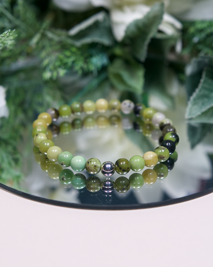 Multi-tonal green round Chrysoprase beaded bracelet with sterling silver accent bead on mirrored plate