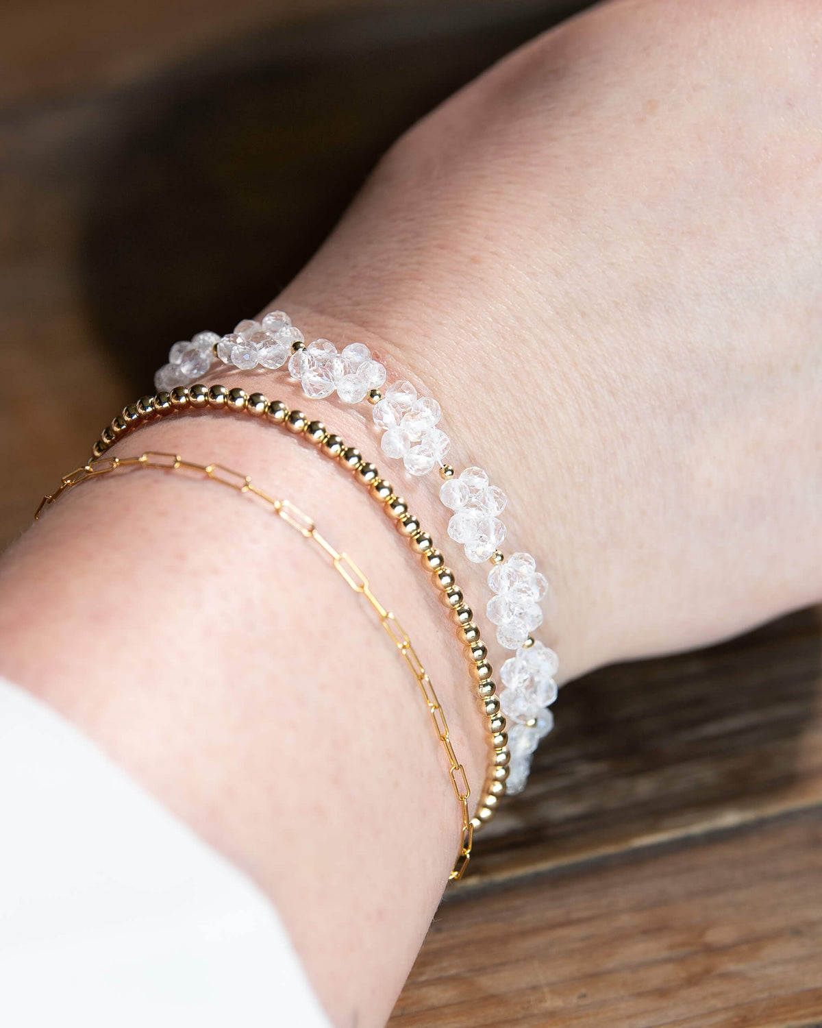 Clear quartz beaded daisy chain bracelet with 14k gold-filled details and spring ring clasp.
