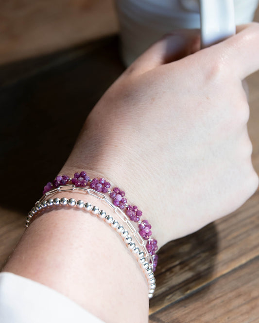 Pale and dark Ruby beaded daisy chain bracelet with sterling silver accents and spring ring clasp.