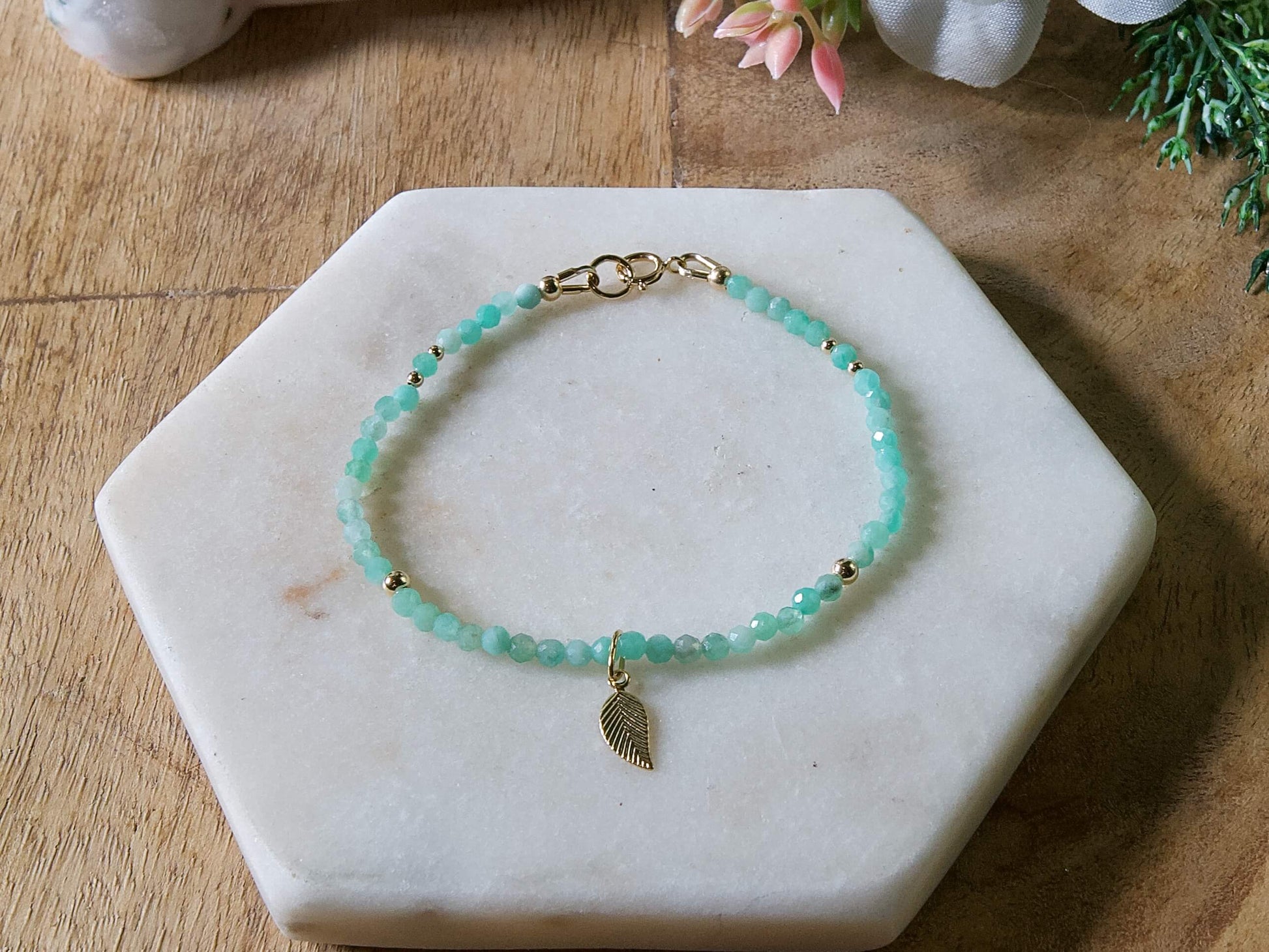 Green emerald gemstone beaded bracelet with 14k gold-filled leaf-shaped charm and spring ring closure.