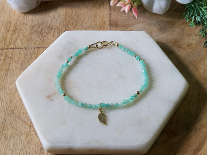 Green emerald gemstone beaded bracelet with 14k gold-filled leaf-shaped charm and spring ring closure.