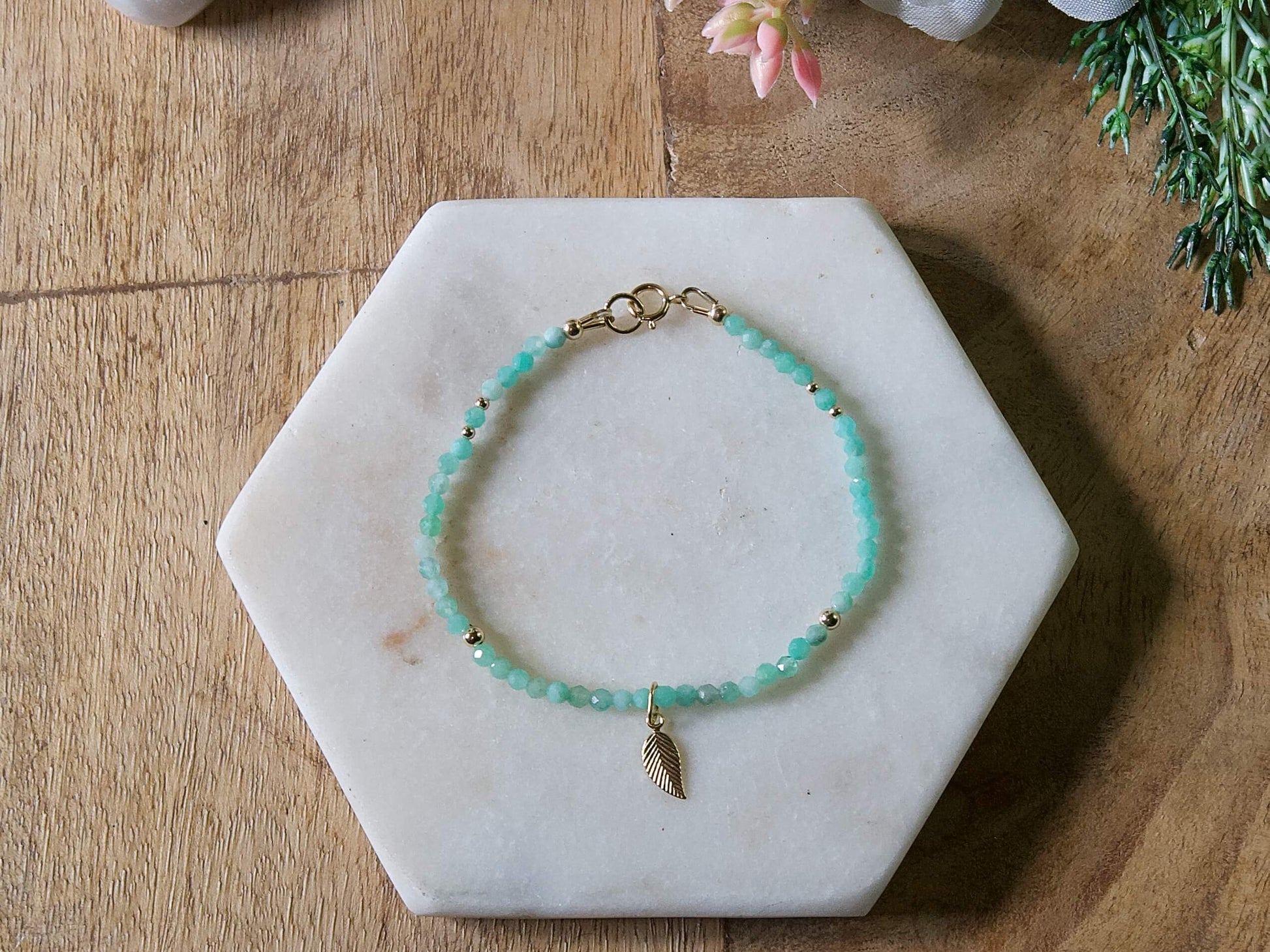 Green emerald gemstone beaded bracelet with 14k gold-filled leaf-shaped charm and spring ring closure.