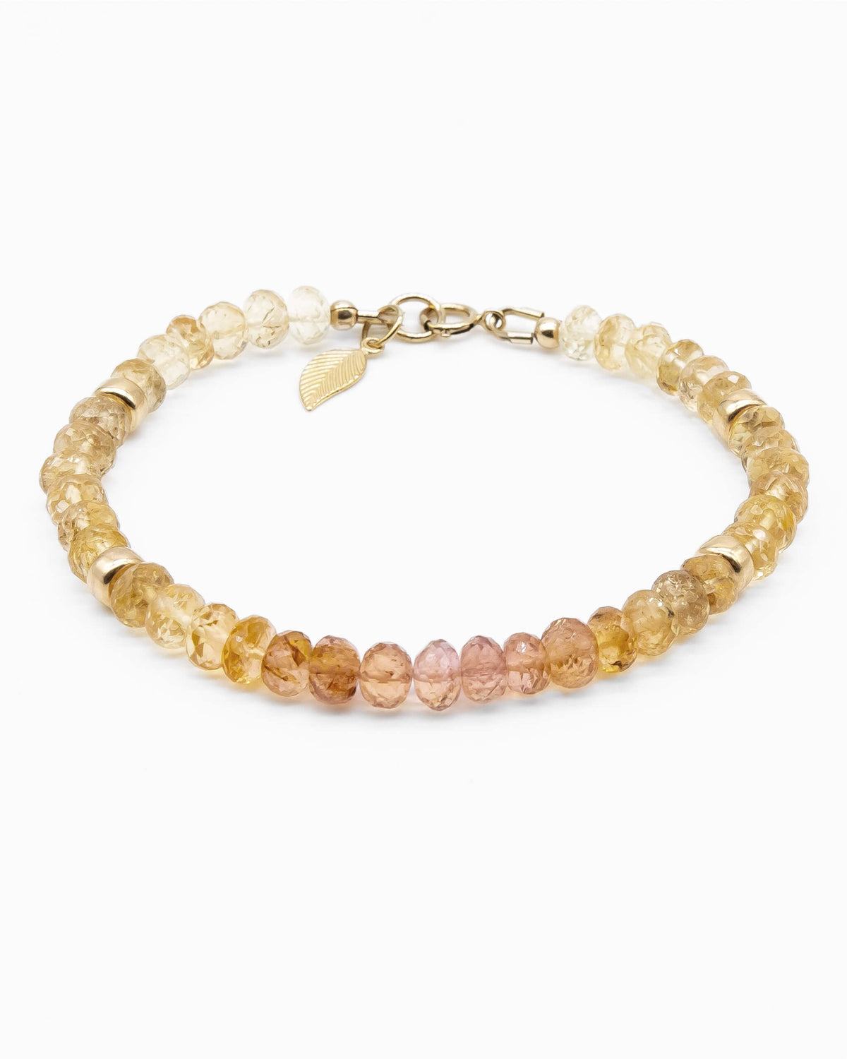 Pink, orange, and yellow Imperial Topaz faceted gemstone beaded bracelet in gradient with 14k gold-filled beads, leaf-shaped charm, and spring ring clasp