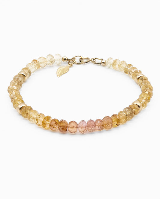 Pink, orange, and yellow Imperial Topaz faceted gemstone beaded bracelet in gradient with 14k gold-filled beads, leaf-shaped charm, and spring ring clasp