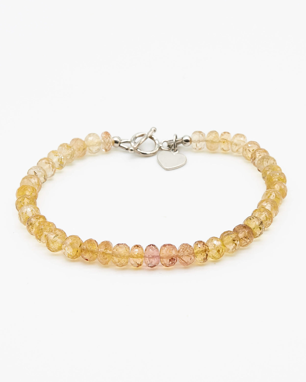 Orange and yellow Imperial Topaz faceted gemstone beaded bracelet in gradient with sterling silver heart-shaped charm, and toggle clasp