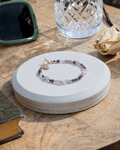 Handmade gemstone bracelet featuring ruby, sapphire, labradorite, and 14k gold-fill accent beads