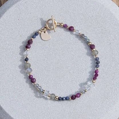 Handmade gemstone bracelet featuring ruby, sapphire, labradorite, and 14k gold-fill accent beads.