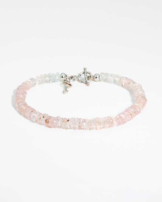 Pale pink, high clarity faceted morganite beaded bracelet with sterling silver key-shaped charm and toggle closure