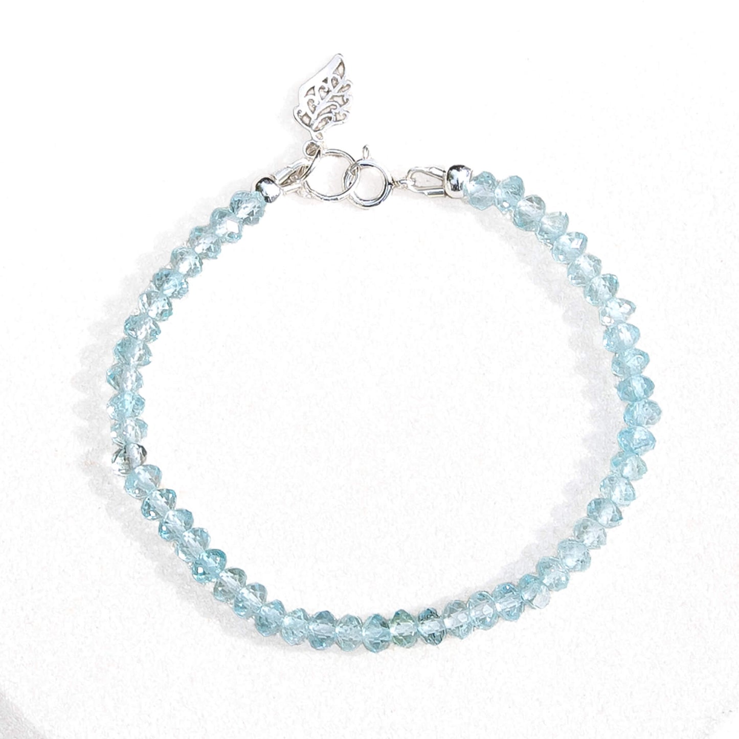 Dizzy Girl Sky Blue Topaz Sterling Silver Faceted Rondelle Bracelet with Leaf Charm