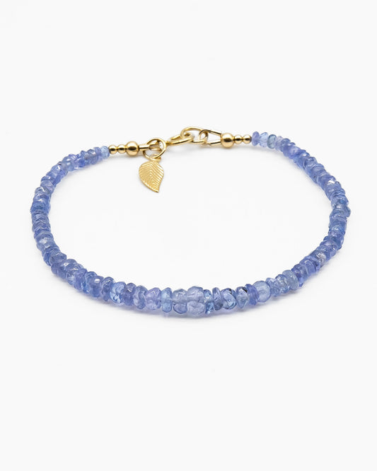 Cornflower blue faceted Tanzanite beaded bracelet in graduated size with 14k gold-filled leaf-shaped charm and spring ring clasp
